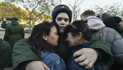 epa10296355 A Russian conscript bids farewell to his relatives before he leaves to serve in the army at a railway station in Sevastopol, Crimea, 09 November 2022. In 2022, as part of the autumn conscription, the number of those called up for military service will be 120 thousand people. Male citizens of the Russian Federation aged 18 to 27 who have not previously completed military service fall under the autumn draft. Conscripts of the autumn conscription will not be sent to serve in the DPR, LPR, Zaporizhzhia and Kherson regions. EPA/STRINGER