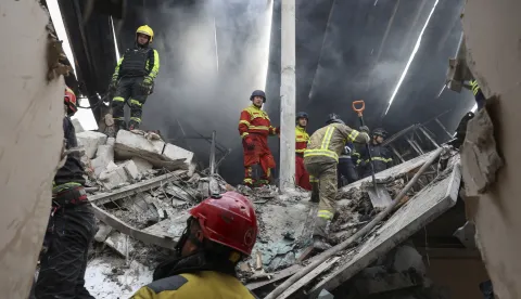 epa12307624 Ukrainian rescuers work at the site of a drone strike on a residential area in Kharkiv, northeastern Ukraine, 18 August 2025, amid the Russian invasion. At least five people, including a child, were killed and more than a dozen others injured after an overnight Russian drone attack on Kharkiv, the city's mayor Ihor Terekhov reported on telegram. EPA/SERGEY KOZLOV