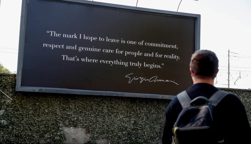 epaselect epa12356376 A person looks at a billboard at Giorgio Armani's funeral chapel on Via Bergognone, Milan, Italy, 06 September 2025. The atelier houses the designer's funeral chapel. Armani died at the age of 91 on 04 September 2025. EPA/MOURAD BALTI TOUATI