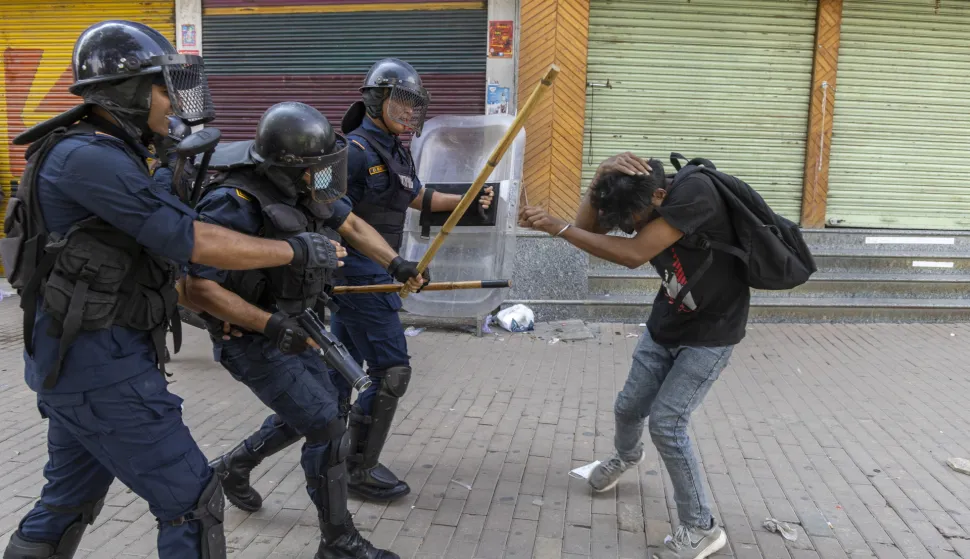 epa12362241 Police clash with a protester in front of the parliament building in Kathmandu, Nepal, 08 September 2025. Young demonstrators gathered in the capital to demand an end to corruption and the lifting of social media bans. The government shut down 26 platforms, including Facebook, YouTube, Instagram, and WhatsApp, after they refused to register in Nepal. At least six people were killed and dozens were injured during the protest. EPA/NARENDRA SHRESTHA