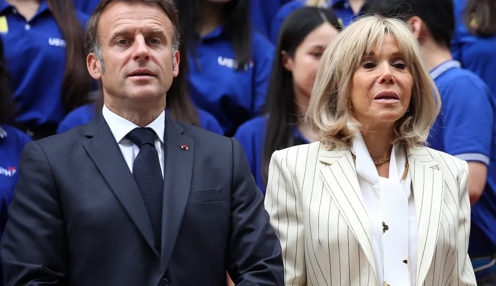 epa12138120 French President Emmanuel Macron (L) and his wife Brigitte Macron (R) pose for a photo as they visit the University of Science and Technology of Hanoi, in Hanoi, Vietnam, 27 May 2025. Macron is on a state visit to Vietnam from 25 to 27 May 2025 EPA/LUONG THAI LINH