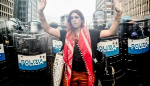 epa12398102 A person gestures in front of policemen during clashes amid the nationwide strike with the slogan 'Let's Block Everything' in solidarity with Palestinians in Gaza and call for a halt to arms shipments to Israel, in Milan, Italy, 22 September 2025. EPA/MOURAD BALTI TOUATI