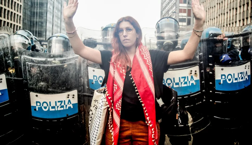 epa12398102 A person gestures in front of policemen during clashes amid the nationwide strike with the slogan 'Let's Block Everything' in solidarity with Palestinians in Gaza and call for a halt to arms shipments to Israel, in Milan, Italy, 22 September 2025. EPA/MOURAD BALTI TOUATI