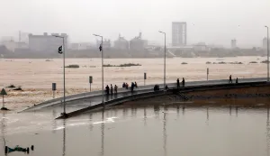 epa12367491 People inspect a partially submerged road amid a fast-flowing torrent in Karachi, Pakistan, 10 September 2025. Heavy monsoon rains, which began on 26 June, continue to cause widespread devastation across Pakistan, with the Sindh Province on high alert as 1.6 million people are at risk of a potential 'super flood', according to The United Nations Office for the Coordination of Humanitarian Affairs (OCHA). EPA/REHAN KHAN
