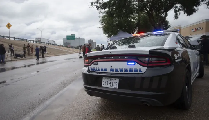 epa12402429 A Dallas Police car parked outside a press conference following a shooting at the United States Immigration and Customs Enforcement (ICE) Field Office, in Dallas, Texas, USA, 24 September 2025. At least two people were killed, the Dallas Police confirmed. According to the US Homeland Security secretary, the shooter also died from 'a self-inflicted gunshot wound' EPA/DANIEL MCGREGOR HUYER