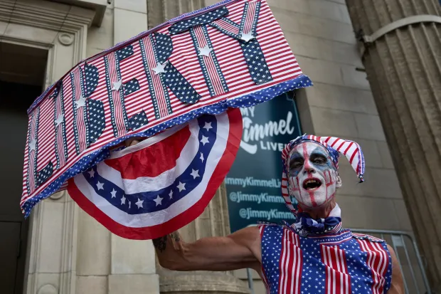 epaselect epa12400920 An activist holds a Liberty sign in front of Jimmy Kimmel Live studios in Los Angeles, California, USA, 23 September 2025. Jimmy Kimmel's late-night show, 'Jimmy Kimmel Live!,' will be back on air for the first time since ABC and Disney pulled the program last week. The show's hiatus came after Mr. Kimmel made comments on air about the man accused of fatally shooting Charlie Kirk, the right-wing activist. EPA/ALLISON DINNER