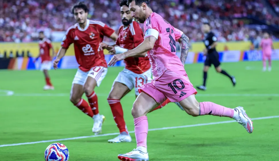 epa12176477 Inter Miami CF's Lionel Messi (R) in action against Al Ahly SC's Marawan Attia during the FIFA Club World Cup 2025 group stage match between Al Ahly SC and Inter Miami CF at Hard Rock Stadium in Miami, USA, 14 June 2025. EPA/CRISTOBAL HERRERA-ULASHKEVICH