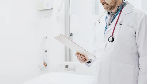Doctor reading a coronavirus patient medical chart