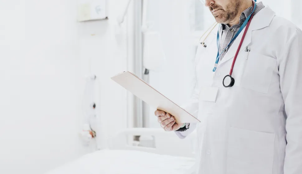 Doctor reading a coronavirus patient medical chart