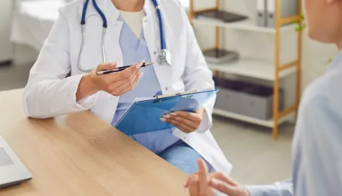 Close up shot of a doctor or nurse hands during a medical consultation and conversation with a patient in the hospital. This interaction highlights healthcare, examination, and patient treatment.