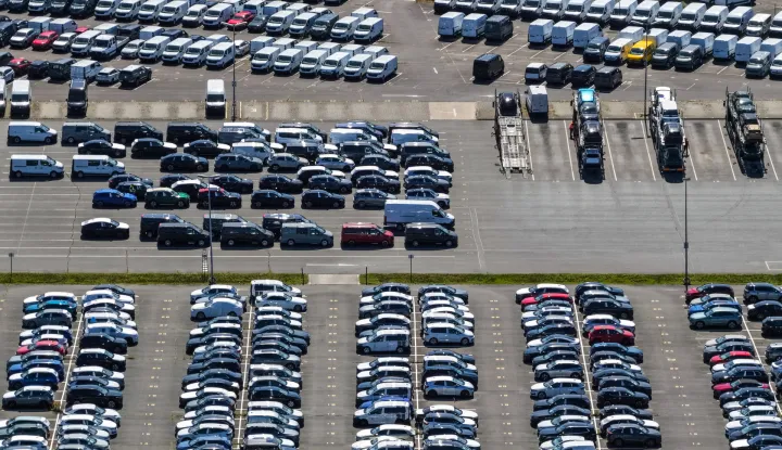 epa12308291 A drone view shows new cars on an industrial site in Seddin, Germany, 18 August 2025. Demand for electric cars continues to rise. According to the Federal Motor Transport Authority (KBA), more than 48,614 new battery electric vehicles were registered in July, representing 18.4 percent of all new cars and a 58 percent increase compared to the same month last year. Almost one in five new cars was a battery electric vehicle. EPA/HANNIBAL HANSCHKE