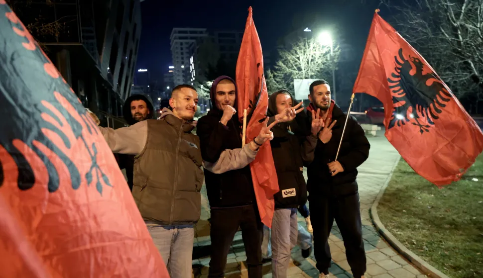 epa11885257 Supporters of the Prime Minister and leader of the 'Vetevendosje' party, Albin Kurti, hold Albanian flags in Pristina, Kosovo, 09 February 2025. The Republic of Kosovo held the parliamentary elections with Kurti's party leading with 42 percent of the vote, a drop from the 50 percent Kurti received in 2021. EPA/GEORGI LICOVSKI