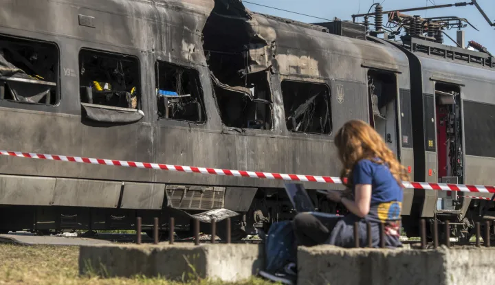 epa12329346 A woman sits by an Intercity+ high-speed passenger train damaged in a morning Russian attack in Kyiv, Ukraine, 28 August 2025, amid the ongoing Russian invasion. Russia struck the Intercity train depot and a railway junction in Kyiv, damaging one train but causing no injuries among depot workers, who were in shelters, according to Ukrzaliznytsia Chairman Oleksandr Pertsovsky. At least 14 people, including three children, were killed and 38 injured in the capital as Russia launched an overnight attack with 598 drones and 31 missiles, according to the State Emergency Service. EPA/MAXYM MARUSENKO