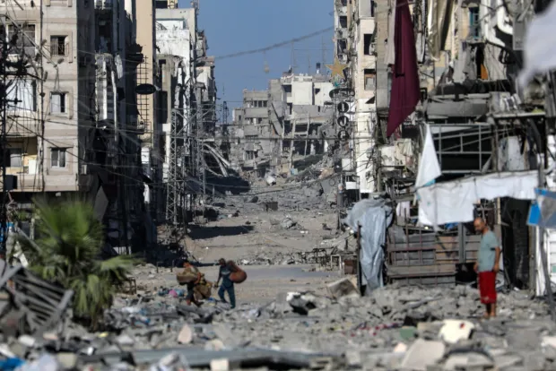 epa12438380 Palestinians move on the damaged Al-Nassr street during an Israeli military operation in Gaza City, Gaza Strip, 07 October 2025. According to the UN around 90 percent of the population or 1.9 million people in Gaza have been displaced since the start of the conflict. More than 67,000 Palestinians have been killed in the Gaza Strip since October 2023, according to the Palestinian Ministry of Health, and about 1,200 Israelis have been killed since the launch of an Israeli military campaign in response to a cross-border attack by Hamas on 07 October 2023. EPA/MOHAMMED SABER