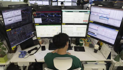 epa12366435 A South Korean dealer works in front of monitors at the Hana Bank in Seoul, South Korea, 10 September 2025. The benchmark Korea Composite Stock Price Index (KOSPI) hit a four-year high, closing at 3,314.53, up 54.48 points or 1.67 percent from the previous session. EPA/JEON HEON-KYUN