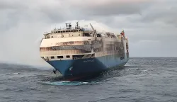 epa09775510 An undated handout photo made available by the Portuguese Navy (Marinha Portuguesa) shows smoke billowing from the burning 'Felicity Ace' ship, seen from the Portuguese Navy NRP Setubal offshore patrol vessel, southeast of the Azores in the Atlantic, Portugal (issued 21 February 2022). According to a statement released by the Felicity Ace Incident Information Centre, a fire broke out on the MOL operated Panama-flagged car carrier 'Felicity Ace' some 90 nautical miles southwest of the Azores in the Atlantic on 16 February, while on his way from Germany to the USA. All 22 crew members were safely evacuated from the ship and taken ashore. According to MOL Ship Management, two large tugs with firefighting equipment from Gibraltar were arranged to support the vessel, as well as a salvage craft with firefighting equipment from Rotterdam set to arrive between 23 to 24 February. EPA/PORTUGUESE NAVY HANDOUT -- MANDATORY CREDIT -- HANDOUT EDITORIAL USE ONLY/NO SALES