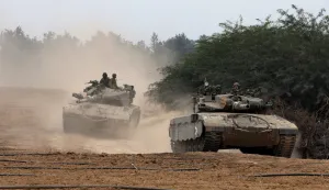 epa11011656 Israeli soldiers aboard armoured fighting vehicles maneuver at an area near the border with the Gaza Strip, in southern Israel, 05 December 2023. Israeli forces resumed military strikes on Gaza after a week-long truce ended on 01 December. More than 15,500 Palestinians and at least 1,200 Israelis have been killed, according to the Palestinian Ministry of Health and the Israel Defense Forces (IDF), since Hamas militants launched an attack against Israel from the Gaza Strip on 07 October, and the Israeli operations in Gaza and the West Bank which followed it. EPA/ATEF SAFADI