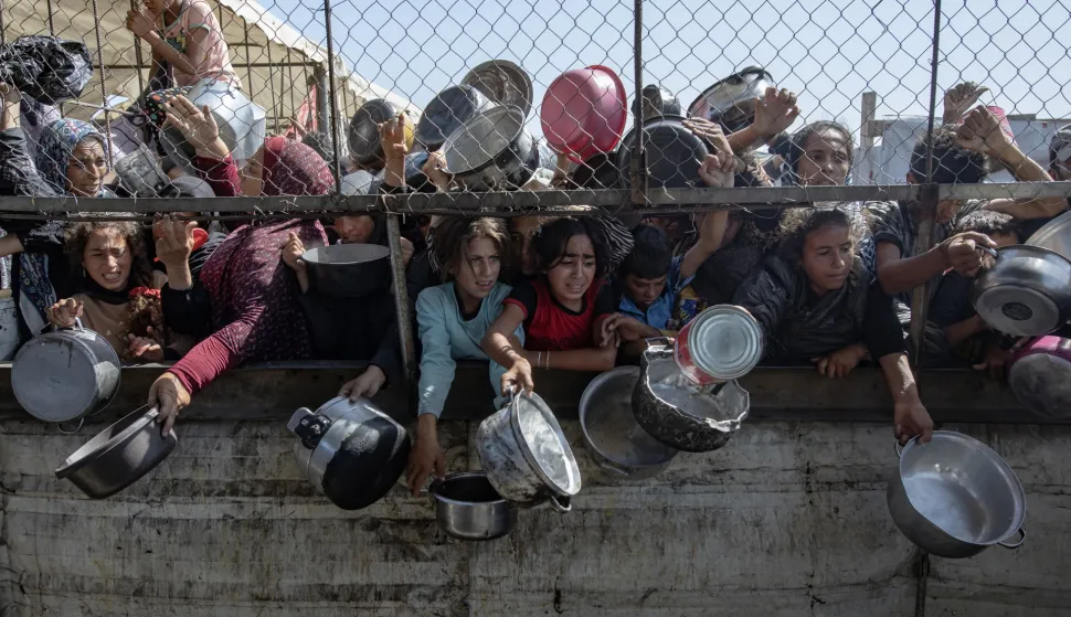 epa12434321 (FILE) - Internally displaced Palestinians gather outside a charity kitchen to receive limited rations amid a shortage of food, in Khan Younis, southern Gaza Strip, 30 May 2025 (reissued 06 October 2025). 07 October 2025 marks two years since the Palestinian militant group Hamas launched a surprise attack on Israel, taking dozens of hostages and killing nearly 1,200 people. In response, Israel began its war on Gaza, which has killed more than 66,000 people, displaced millions and destroyed the Palestinians enclave. EPA/HAITHAM IMAD