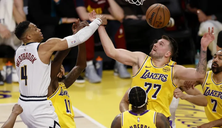 epa11975088 Los Angeles Lakers guard Luka Doncic (R) blocks a shot by Denver Nuggets guard Russell Westbrook (L) during the first quarter of the NBA basketball game between the Denver Nuggets and Los Angeles Lakers in Los Angeles, California, USA, 19 March 2025. EPA/CAROLINE BREHMAN SHUTTERSTOCK OUT