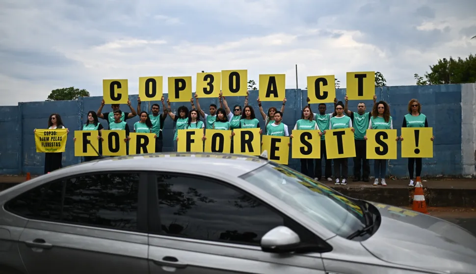 epa12451222 Greenpeace environmental activists hold signs before the opening session of the PRE-COP30 meeting at the International Convention Center in Brasilia, Brazil, 13 October 2025. during the meeting, the Brazilian presidency of COP30 urged the world to take concrete action against global warming. EPA/ANDRE BORGES