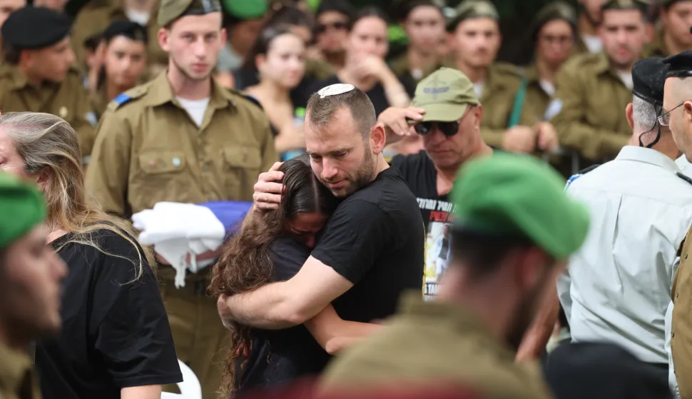 epa12457637 Family members mourn near the coffin of late Israeli soldier and hostage Tamir Nimrodi during his funeral in Kfar Saba, Israel, 16 October 2025. Tamir Nimrodi was kidnapped by Hamas on 07 October 2023 and killed in captivity. His body was returned by Hamas to Israel during the ceasefire agreement. Some 20 bodies of Israeli hostages still remain in Hamas captivity. EPA/ABIR SULTAN