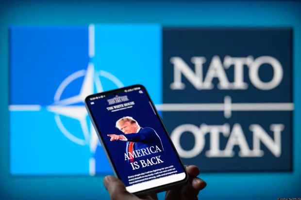 The White House website is displayed on a mobile phone with NATO - OTAN seen in the background, in this photo illustration. Taken in Brussels, Belgium, On 25 January 2025. (Jonathan Raa/Sipa USA) *** Strictly for editorial news purposes only *** Photo: Jonathan Raa/SIPA USA
