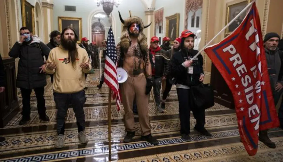 epa08923457 Supporters of US President Donald J. Trump stand by the door to the Senate chambers after they breached the US Capitol security in Washington, DC, USA, 06 January 2021. Protesters stormed the US Capitol where the Electoral College vote certification for President-elect Joe Biden took place. EPA/JIM LO SCALZO
