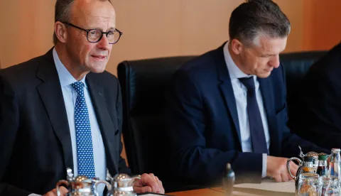 epa12471952 German Chancellor Friedrich Merz (L) looks on next to German Chief of Staff at the Chancellery Thorsten Frei during the weekly cabinet meeting of the German government in Berlin, Germany, 22 October 2025. EPA/CLEMENS BILAN