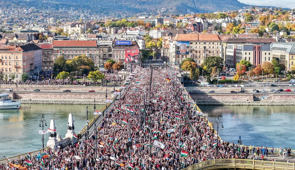 epa12475133 In this picture taken by a drone, participants of the Peace March organized by the pro-government Civil Unity Forum (COF) and its foundation Civil Unity Public Benefit Foundation (COKA) walk on the Margaret Bridge in Budapest, Hungary, 23 October 2025, on the 69th anniversary of the Hungarian revolution and war of independence against communist rule and the Soviet Union in 1956. EPA/ZSOLT CZEGLEDI HUNGARY OUT