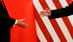 FILE PHOTO: U.S. President Donald Trump and China's President Xi Jinping shake hands after making joint statements at the Great Hall of the People in Beijing, China, November 9, 2017. Damir Sagolj: "It's one of those "how to make a better or at least different shot when two presidents shake hands several times a day, several days in row". If I'm not mistaken in calculation, presidents Xi Jinping of China and Donald Trump of the U.S. shook their hands at least six times in events I covered during Trump's recent visit to China. I would imagine there were some more handshakes I haven't seen but other photographers did. And they all look similar - two big men, smiling and heartily greeting each other until everyone gets their shot. But then there is always something that can make it special - in this case the background made of U.S. and Chinese flags. They shook hands twice in front of it, and the first time it didn't work for me. The second time I positioned myself lower and centrally, and used the longest lens I have to capture only hands reaching for a handshake." REUTERS/Damir Sagolj/File Photo SEARCH "POY TRUMP" FOR THIS STORY. SEARCH "REUTERS POY" FOR ALL BEST OF 2017 PACKAGES. TPX IMAGES OF THE DAY/File Photo Photo: DAMIR SAGOLJ/REUTERS