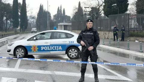 epa06552705 Police guard the entrance to the US embassy building in Podgorica, Montenegro, 22 February 2018. According to media reports, a man attacked the US embassy building at around 12:30 am local time by throwing an explosive device over the compund wall, then blew himself up outside the building. There were no other injuries or fatalities reported. EPA/BORIS PEJOVIC