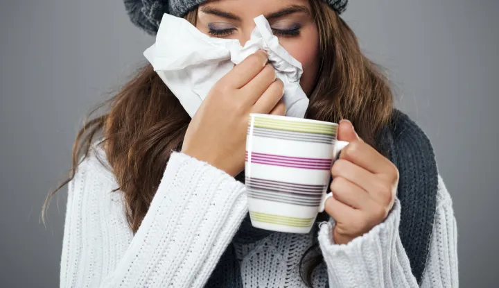 Young woman having flu and blowing her nose at handkerchiefgripa, prehlada, ilustracija, freepik