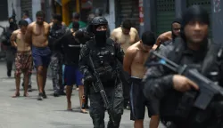epa12487894 Rio de Janeiro Police officers guard a group of people during an operation in Rio de Janeiro, Brazil, 28 October 2025. At least twenty people were killed and fifty were arrested during a major police operation against Comando Vermelho, one of the most powerful organized crime gangs in Rio de Janeiro. EPA/ANTONIO LACERDA