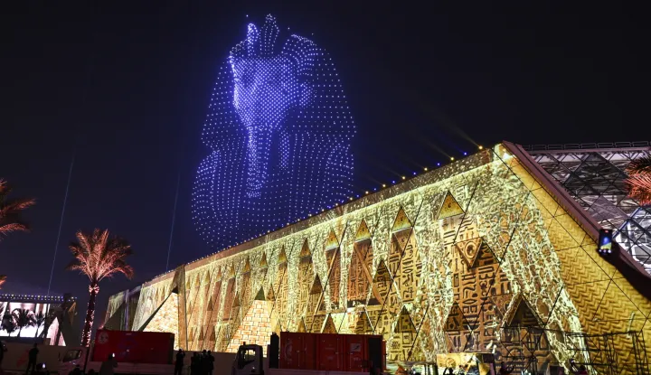 epa12497745 An image created by drones depicting the funerary mask of Tutankhamun lights up the sky above the Grand Egyptian Museum during the opening ceremony in Giza, Egypt, 01 November 2025. The Grand Egyptian Museum, the world's largest museum dedicated to a single civilization, was officially opened on 01 November 2025 with an inauguration ceremony attended by numerous heads of state. EPA/MOHAMED HOSSAM