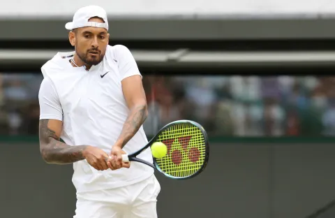 epa10048177 Nick Kyrgios of Australia in action against Stefanos Tsitsipas of Greece during their Men's third round match at the Wimbledon Championships, in Wimbledon, Britain, 02 July 2022. EPA/KIERAN GALVIN  EDITORIAL USE ONLY