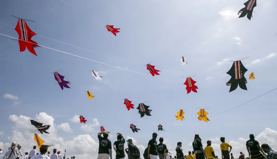 epa06854135 Balinese people fly their traditional kites during the Bali Kite Festival in Sanur, Bali, Indonesia, 01 July 2018. The primary colors used for Balinese kites are black, red, white and gold/yellow, which represent the incarnations of the Hindu deities. The festival is a popular tourist attraction in Bali. EPA/MADE NAGI