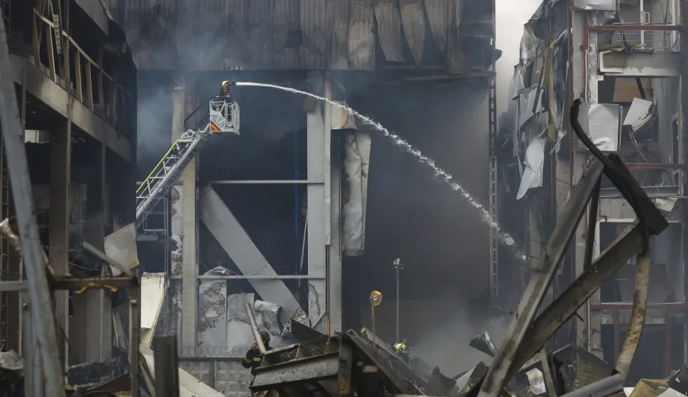epa12480956 Ukrainian rescuers work at the site of a Russian missile strike in Kyiv, Ukraine, 25 October 2025, amid the Russian invasion. At least two people were killed and 13 others injured after Russian forces launched an overnight attack on Kyiv, the State Emergency Service of Ukraine reported. EPA/SERGEY DOLZHENKO