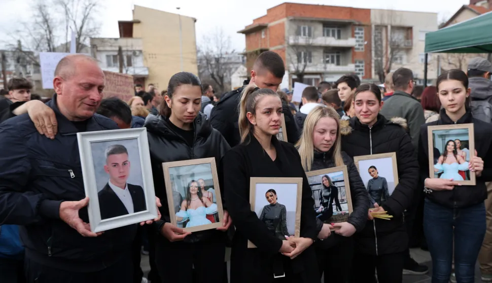 epa11969873 People hold photos of their loved ones while honoring the victims who lost their lives in the fire in the 'Club Pulse' nightclub in Kocani, Republic of North Macedonia, 17 March 2025. A fire at a discotheque in Kocani in the early hours of 16 March 2025 claimed the lives of at least 59 people and left over 100 injured, according to initial reports from the Directorate for Protection and Rescue and the Center for Crisis Management. EPA/GEORGI LICOVSKI