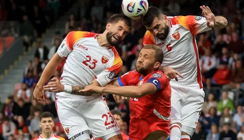 epa12160881 Tomas Soucek of Czechia (C) in action against Nikola Sipcic of Montenegro (L) during the FIFA World Cup 26 qualification match between the Czech Republic and Montenegro in Plzen, Czech Republic, 06 June 2025. EPA/MARTIN DIVISEK