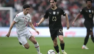 epa12529396 Portugal player Vitinha (R) in action against Armenia player Ranos (L) during the FIFA World Cup 26 UEFA Qualifiers match between Portugal and Armenia held at Dragao Stadium in Porto, Portugal, 16 November 2025. EPA/MANUEL FERNANDO ARAUJO