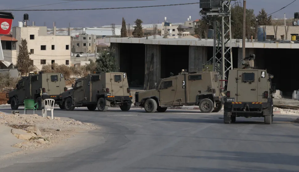 epa12502793 Israeli troops patrol during an army operation in Tamoun near Tubas city, West Bank, 04 November 2025. According to the Palestinian news agency Wafa, Israeli forces raided Tamoun, imposed a siege on the western area of the town, and arrested four Palestinians. EPA/ALAA BADARNEH