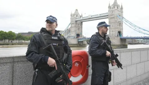 epa06369453 (FILE) - British police on dutyl during a vigil for the victims of the London Bridge terror attacks by the City Hall in London, Britain, 05 June 2017, (reissued 05 December 2017). Media reports on 05 December 2017 state that the report by David Anderson QC, a former terrorism law reviewer asked by the British Home Secretary to audit internal MI5 and police reviews, is published on 05 December 2017. The terror attacks in 2017 - at Manchester Arena, London Bridge, Finsbury Park and Westminster - has placed the spotlight on the British security services. The British internal security service MI5 and police launched internal reviews following the atrocities between March and June 2017 and the findings of the reviews looking at intelligence handling by the organisations are to be seen in the review published by the Home Secretary. EPA/FACUNDO ARRIZABALAGA *** Local Caption *** 53568746