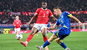epa12534383 Kevin Danso of Austria (L) in action against Amar Memic of Bosnia & Herzegovina during the FIFA World Cup 26 UEFA qualifier between Austria and Bosnia & Herzegovina in Vienna, Austria, 18 November 2025. EPA/MAX SLOVENCIK