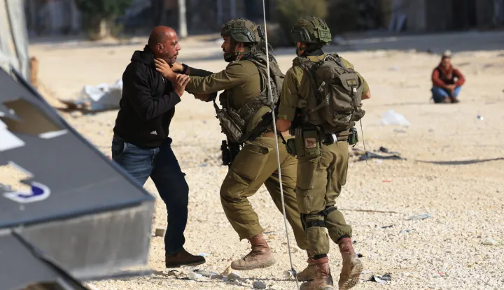 epa12533344 Israeli soldiers arrest displaced Palestinians from Nur Shams refugee camp attempting to return to their camp, as an Israeli military operation continues, near the West Bank city of Tulkarem, 18 November 2025. Two Palestinians were wounded by Israeli soldiers in the city of Tulkarem amid an ongoing military operation that has continued for the 295th consecutive day, according to the Palestinian health ministry and the news agency Wafa. EPA/ALAA BADARNEH
