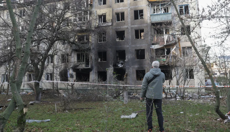 epa12525432 Residents at the site of a Russian strike on a five-storey residential building in Kyiv, Ukraine, 14 November 2025, amid the Russian invasion. At least four people were killed and dozens others injured, including two children, in result of the overnight combined Russian attack on Kyiv using more than 400 shock drones and about 20 missiles of different types, according to the Kyiv City Military Administration. EPA/SERGEY DOLZHENKO