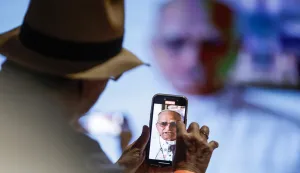 epaselect epa12532587 A person records a video of Pope Leo XIV at the Amazonian Museum in Belem, Brazil, 17 November 2025. Leo XIV urged the adoption of 'concrete actions' to address climate change and lamented the lack of 'political will on the part of some,' in a message sent to the local churches of the Global South, in the context of the UN Climate Change Conference (COP30). EPA/FRAGA ALVES