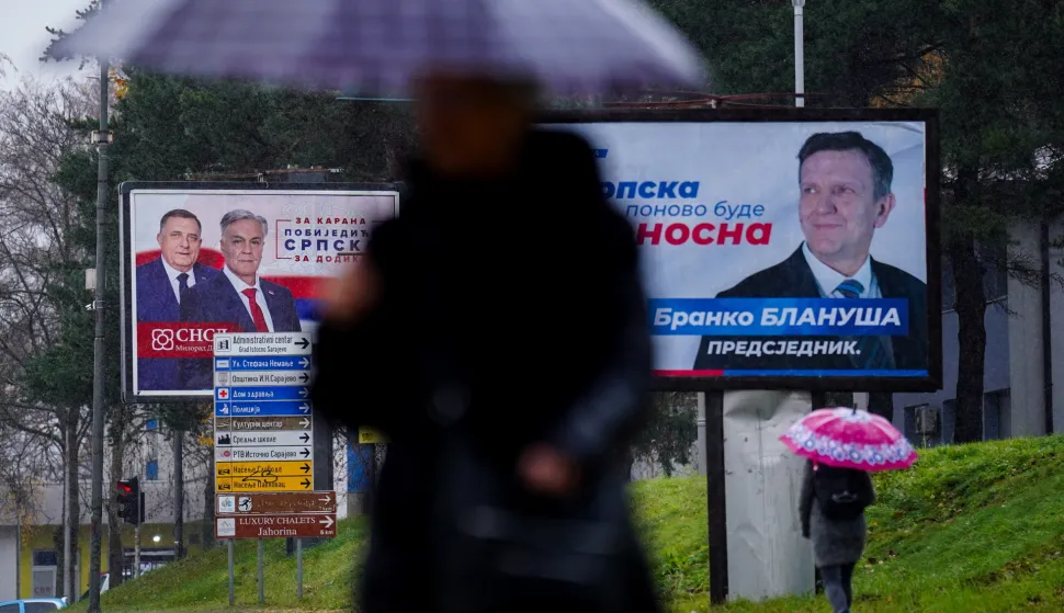 epa12540169 Pedestrians walk past campaign posters depicting Presidential candidates Branko Blanusa and Sinisa Karan ahead of the early presidential elections in Republika Srpska, in Istocno Sarajevo, Bosnia and Herzegovina, 21 November 2025. The early election, scheduled for 23 November 2025, was triggered when the incumbent, Bosnian Serb political leader Milorad Dodik, was removed from office on 12 June 2025 following a court conviction that included a one-year prison sentence and a six-year ban from political office. EPA/NIDAL SALJIC