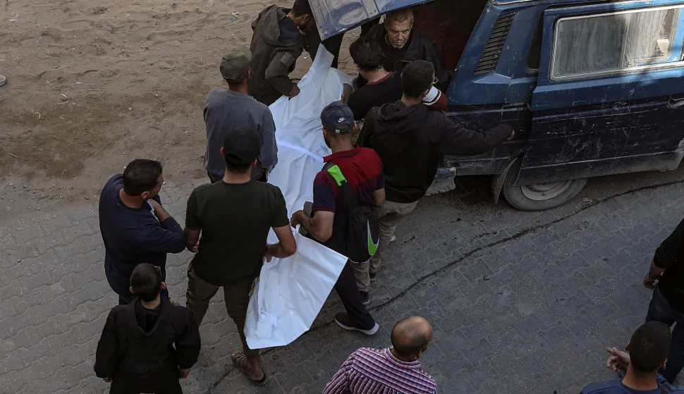 epa12543807 Palestinians carry the body of a member of the Al Khoudary family, at Al Shifa hospital in Gaza City, 23 November 2025. According to the Palestinian Ministry of Health in Gaza, at least 24 Palestinians were killed November 22 in Israeli air strikes on the Gaza Strip. EPA/MOHAMMED SABER
