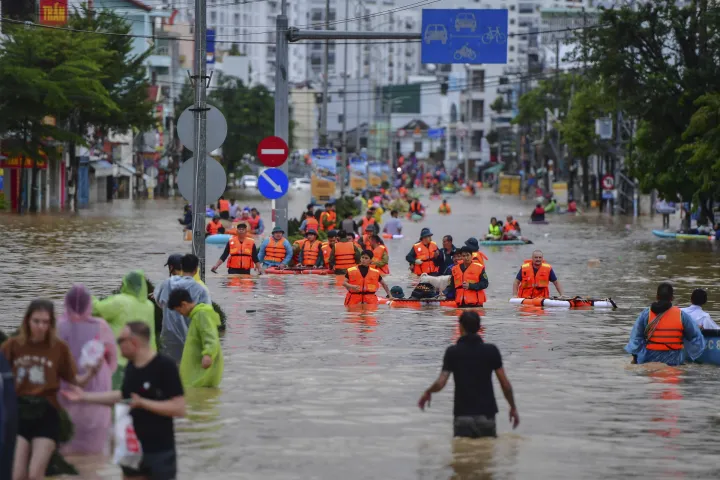 epa12539407 People wade through flood water in Nha Trang, Khanh Hoa province, Vietnam, 20 November 2025 (issued on 21 November 2025). At least 40 people were killed after torrential rain and flooding in four provinces in southern and central Vietnam, state media reported. EPA/STRINGER