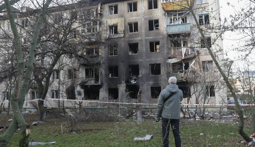 epa12525432 Residents at the site of a Russian strike on a five-storey residential building in Kyiv, Ukraine, 14 November 2025, amid the Russian invasion. At least four people were killed and dozens others injured, including two children, in result of the overnight combined Russian attack on Kyiv using more than 400 shock drones and about 20 missiles of different types, according to the Kyiv City Military Administration. EPA/SERGEY DOLZHENKO